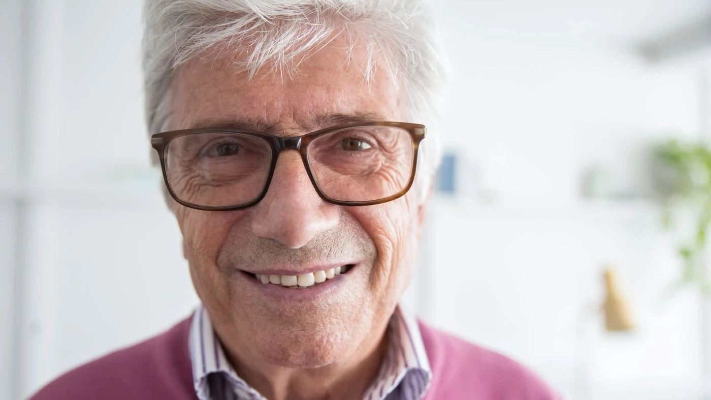 An older man smiling